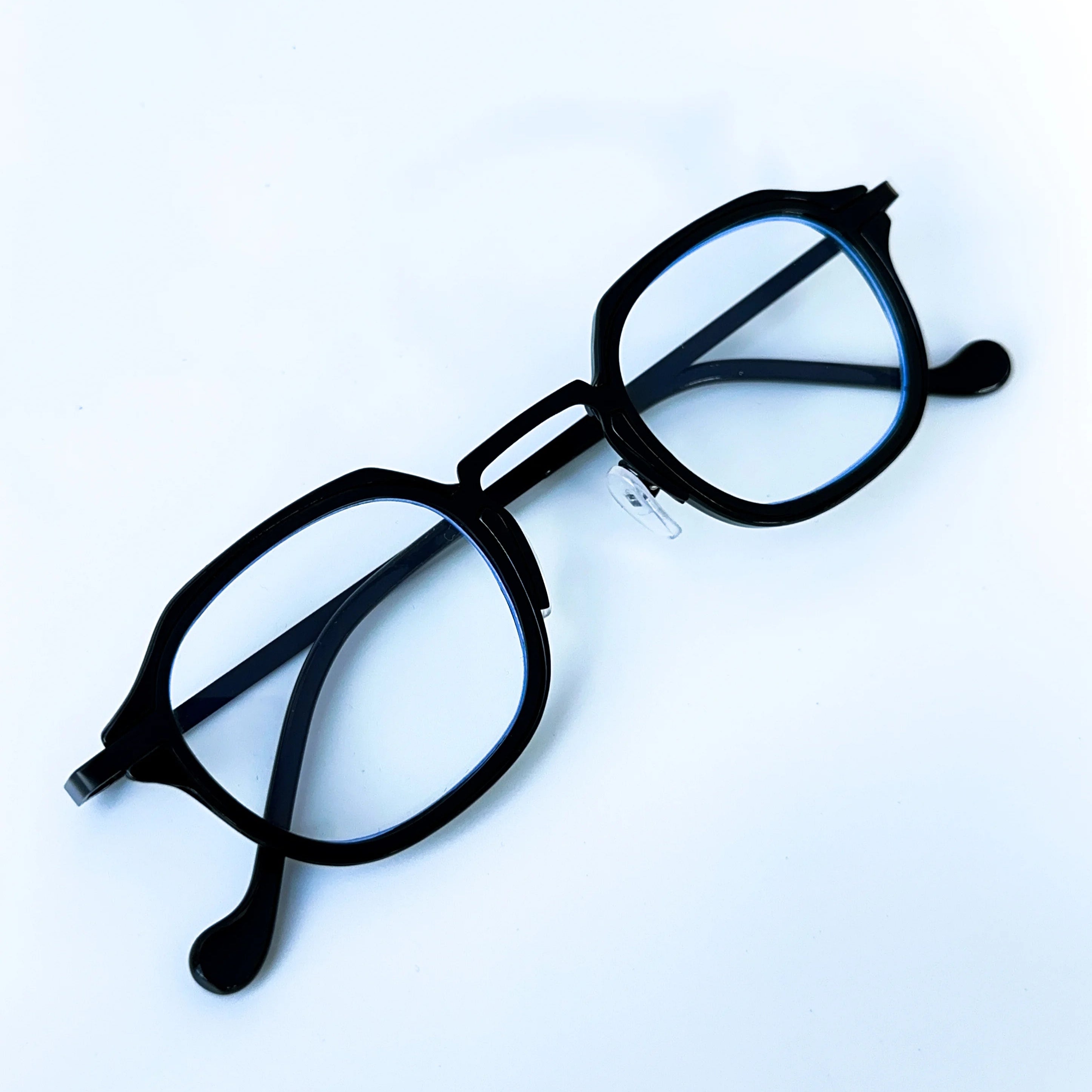 Black eyeglasses on a light blue background