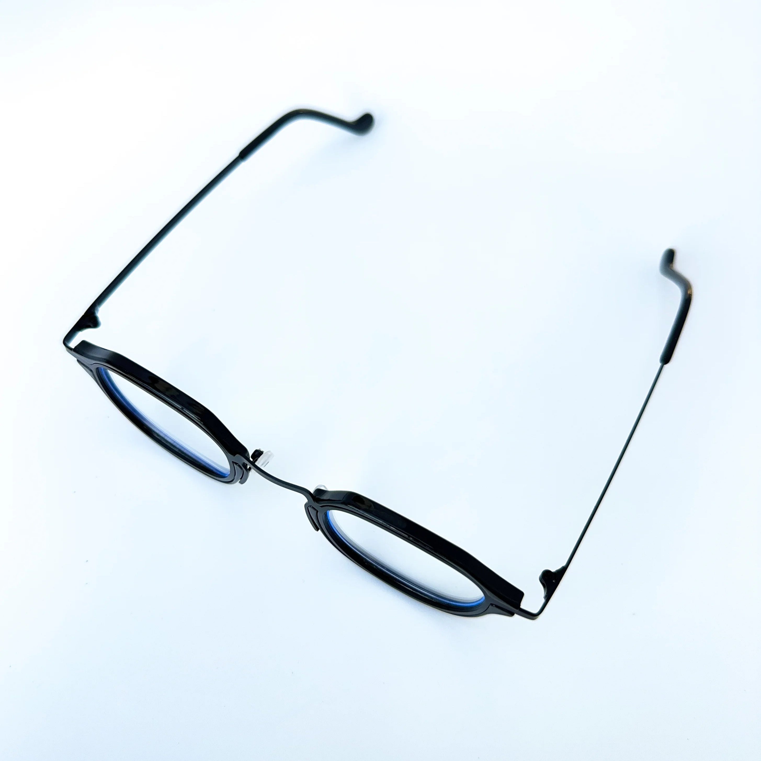 Black eyeglasses on a light blue background