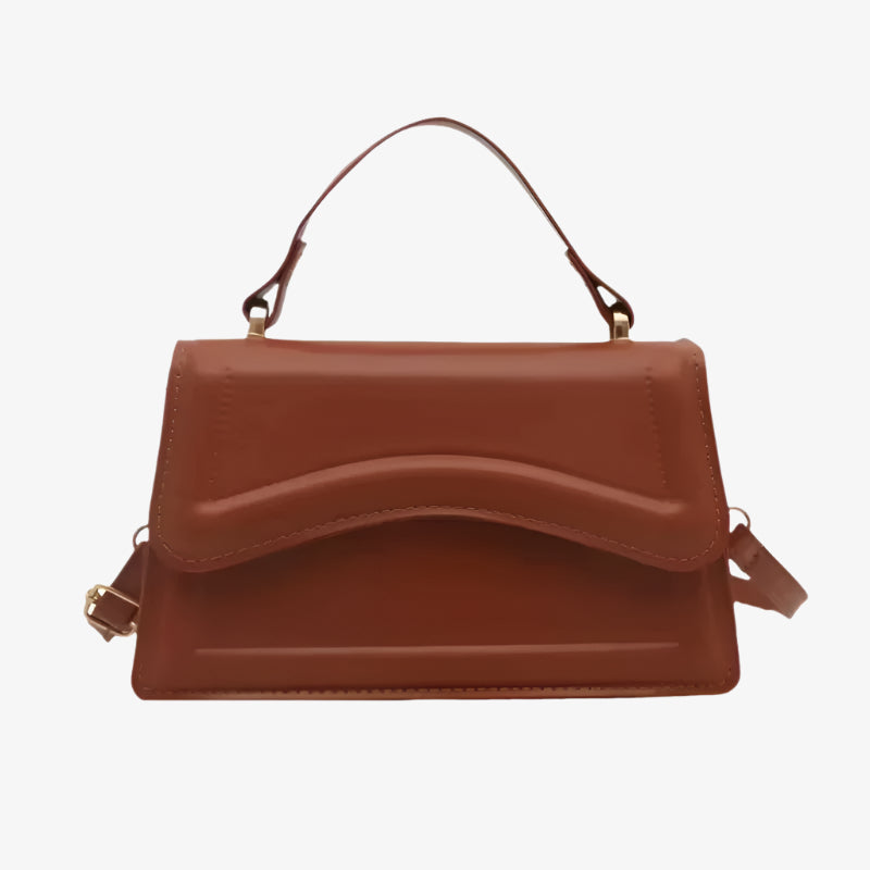 Brown handbag with a strap on a white background