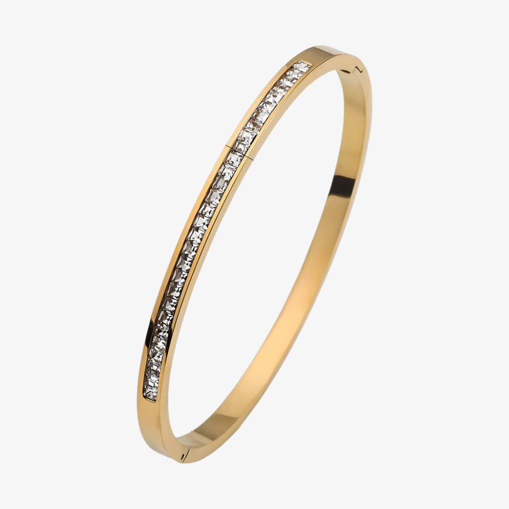 Gold bracelet with measurements on a white background