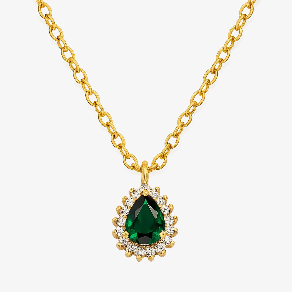 Gold necklace with a green gemstone pendant on a white background