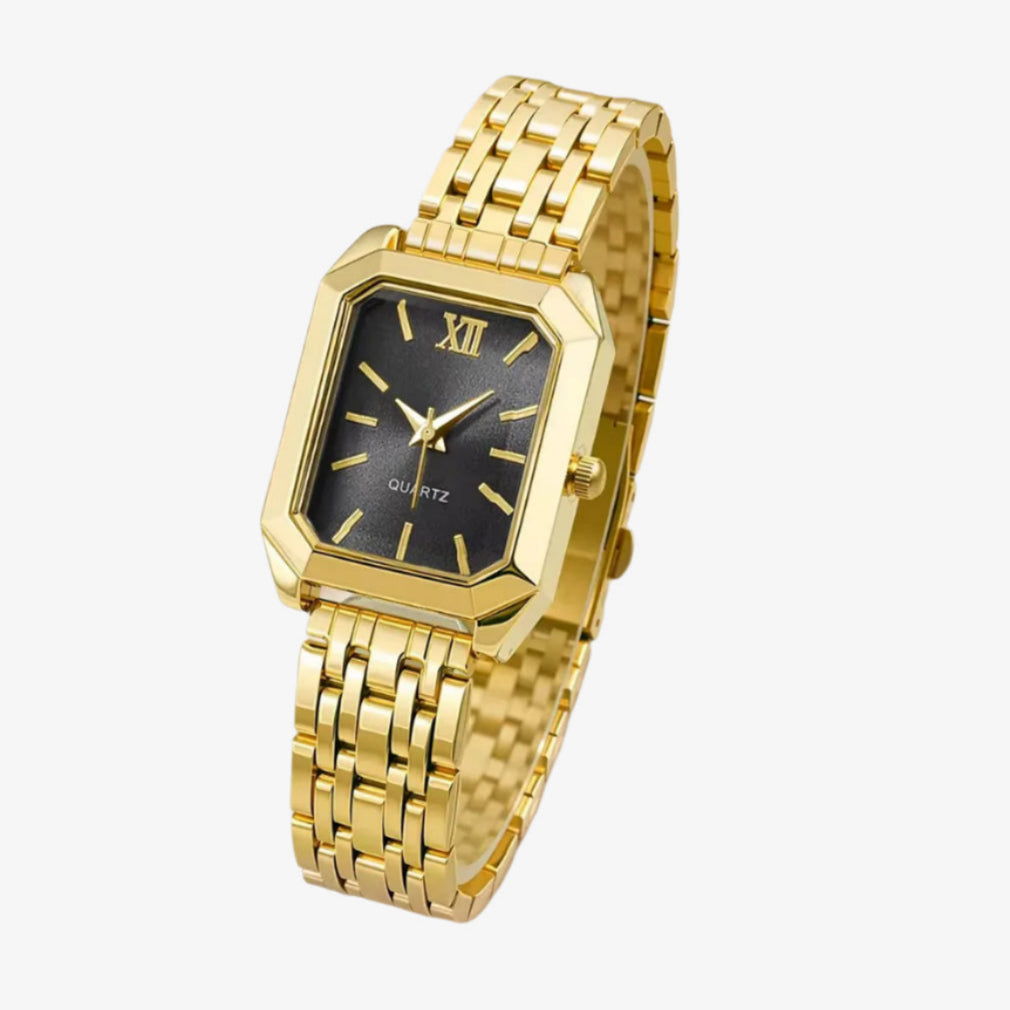 Gold wristwatch with a black face on a white background