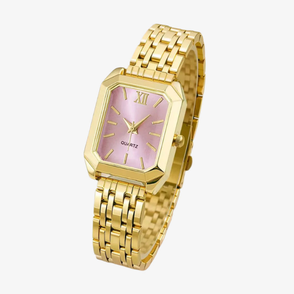 Gold wristwatch with a pink face on a white background