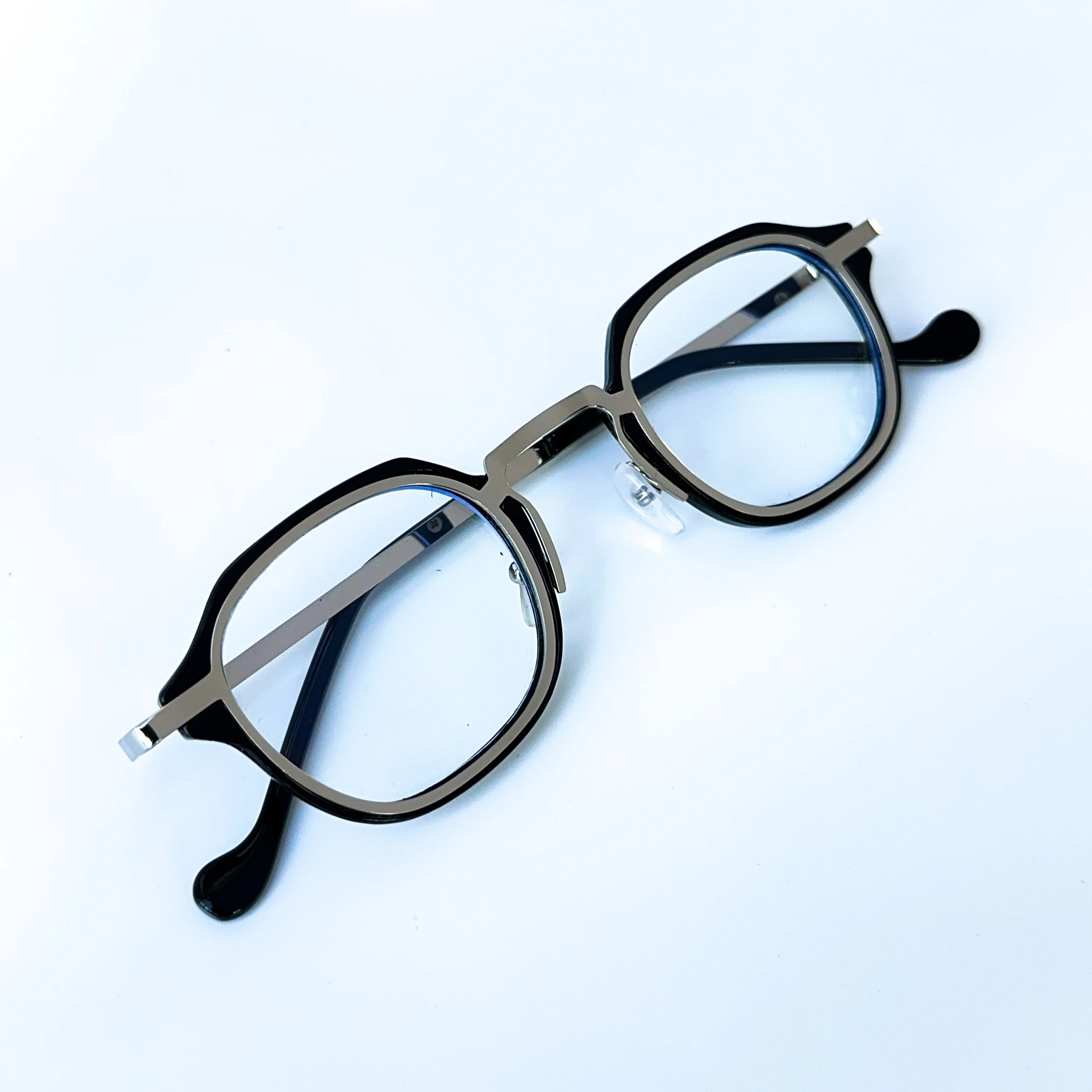 Round eyeglasses with thin frame on a light blue background