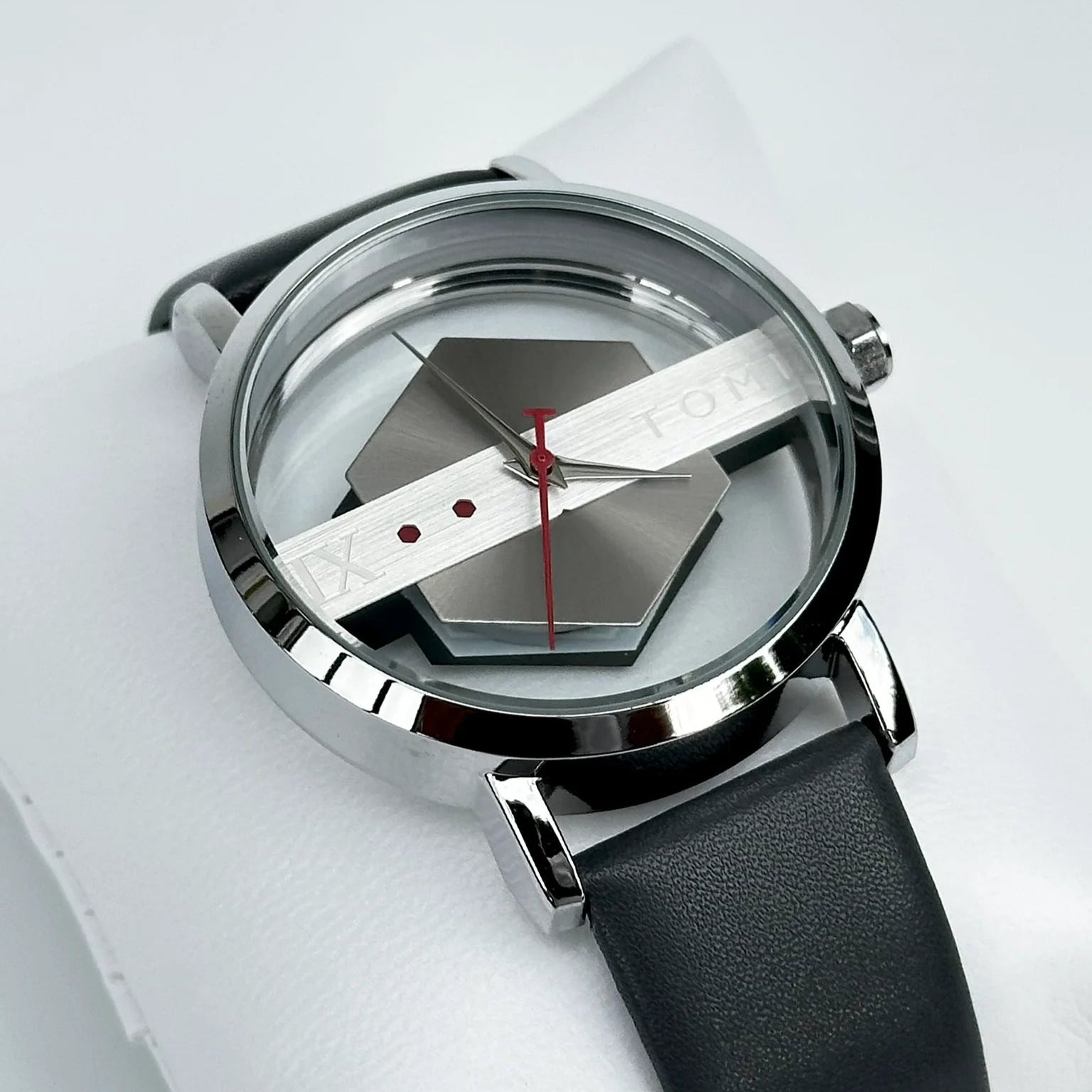 Modern watch with black leather strap and silver case on a white background