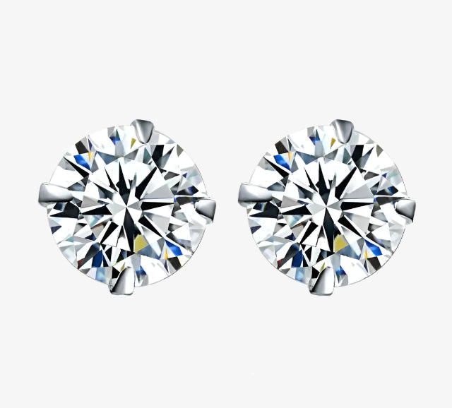 Pair of diamond stud earrings on a white background