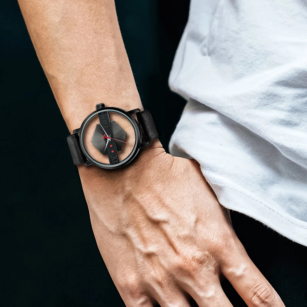 Person wearing a black wristwatch on a dark background