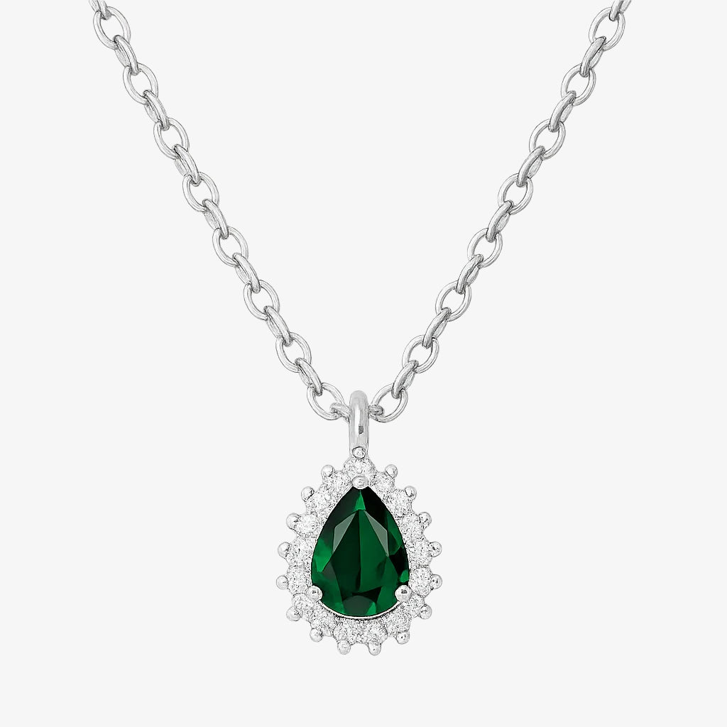 Silver necklace with a green teardrop pendant on a white background