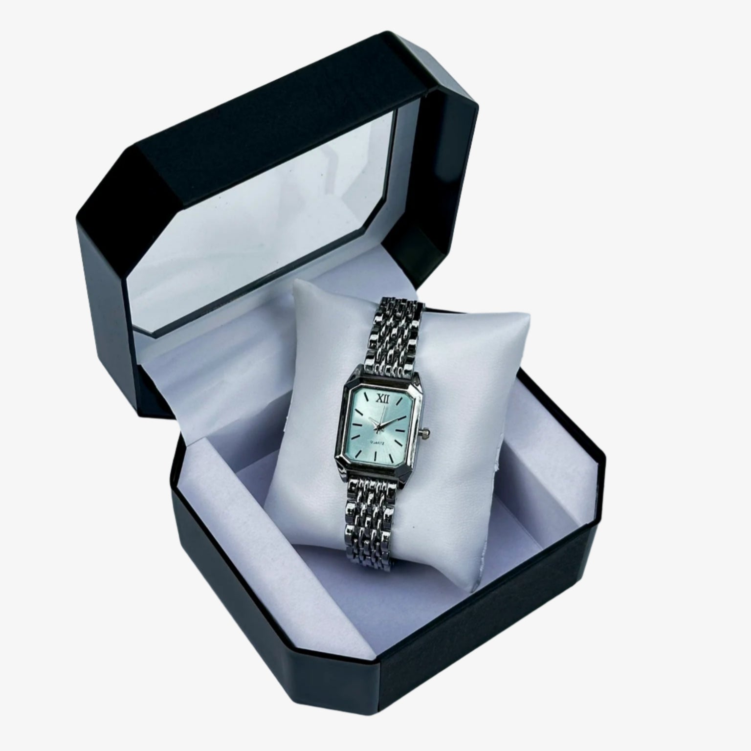 Silver watch in a black and white box on a light gray background