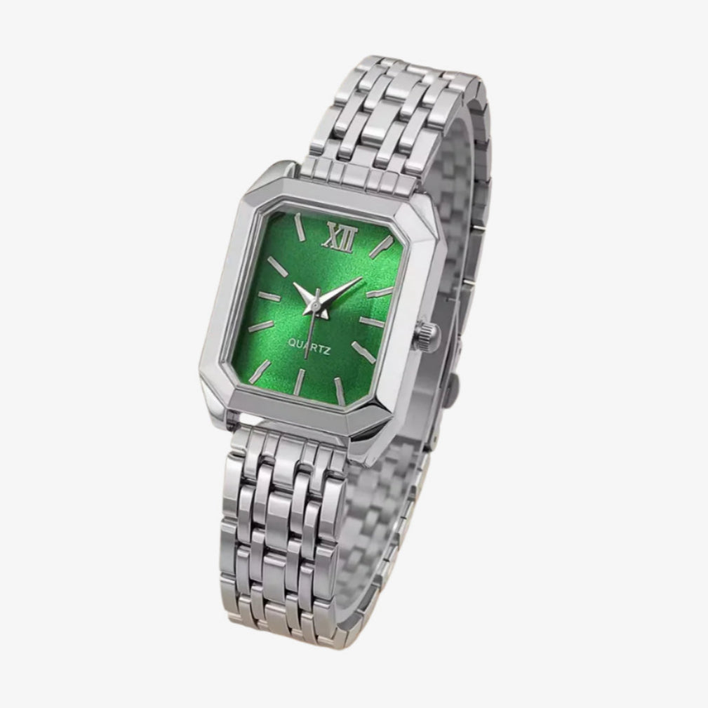 Silver watch with a green face on a white background