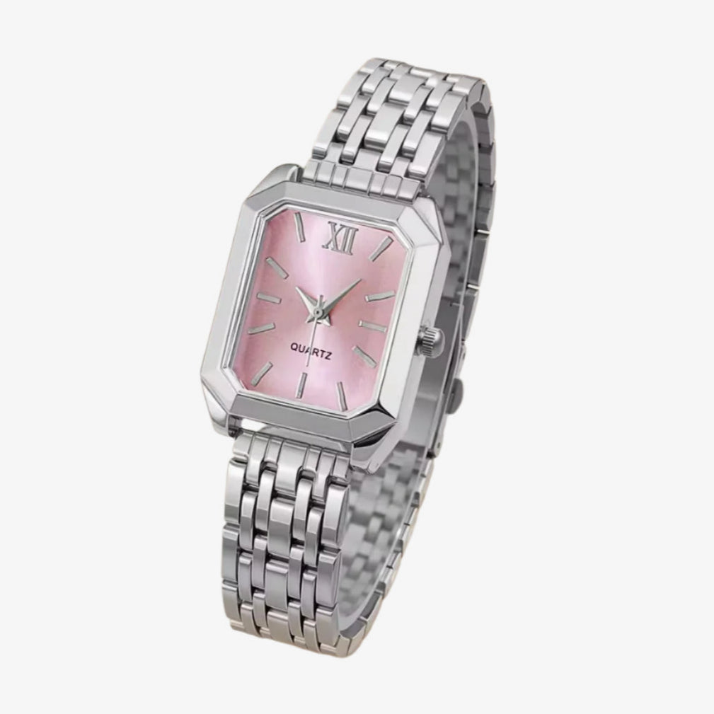 Silver watch with a pink face on a white background