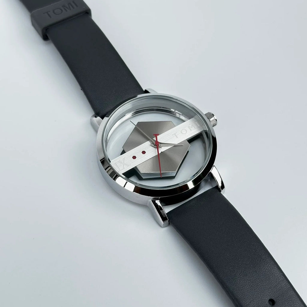 Watch with black strap and unique face design on a light gray background