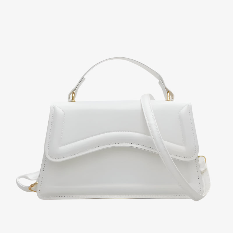 White handbag with gold accents on a white background