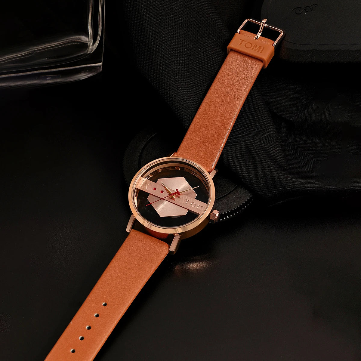 Wristwatch with brown leather strap and rose gold case on a dark background